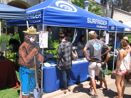 Smokey the Bear stands near Surfrider Foundation booth.