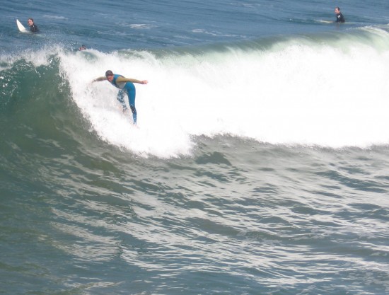 Surfer riding a nice wave on a sunny day.