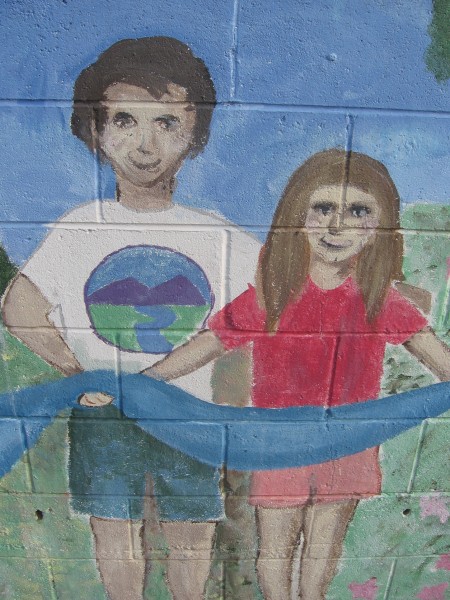 Two figures hold up the long blue ribbon of life.