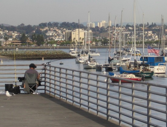 Fisherman at one end of Shelter Island pier.