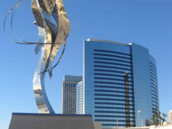 Flame of Friendship with hotels in background.