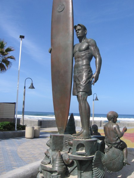 Bronze surfer holds surfboard in Imperial Beach.