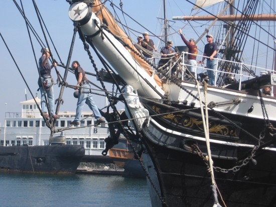 People tangled in picturesque ship's rigging.
