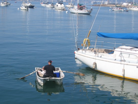 Rowing to a boat moored in San Diego Bay's crescent area.