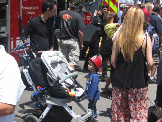 Kid checks out a fire engine.