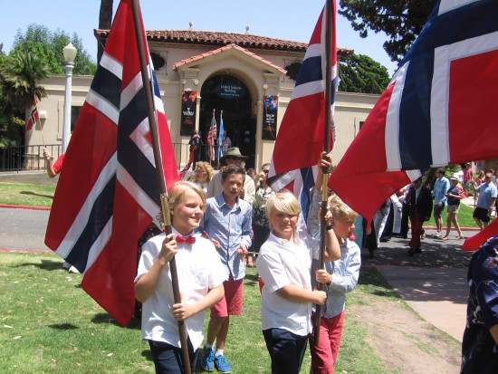 Parading flags open House of Norway lawn program.