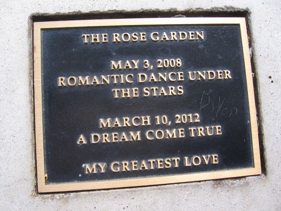 Plaque on one gazebo bench with romantic sentiment.