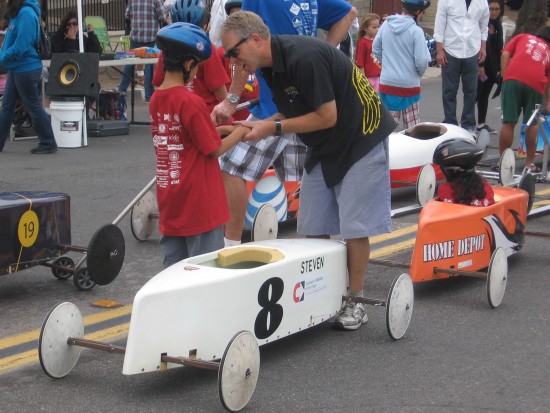 Boy gets encouragement before racing in Soap Box Derby.