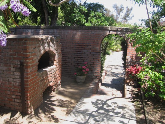 Outdoor archway and oven are part of the delightful scenery.