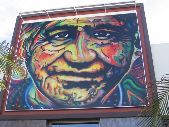 Face on bold mural at Mercado del Barrio.