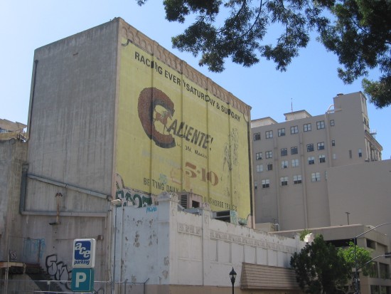 Large old Caliente racetrack sign on building.