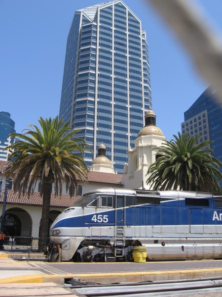 Amtrak train parked by historic Santa Fe Depot.