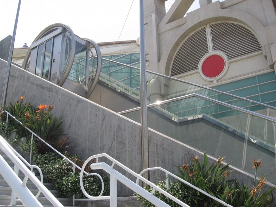 Cool round glass elevator at top of incline.