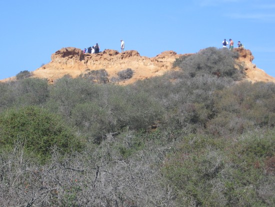 People enjoy vistas from atop sandstone formation.