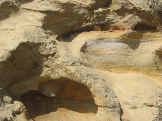 Erosion of layered sandstone creates unusual, fluid forms.
