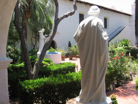 Flowers and peaceful walkways lead to holy figures.