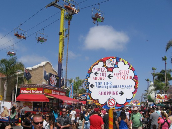Big crowd outside enjoys fair beneath the Skyway.