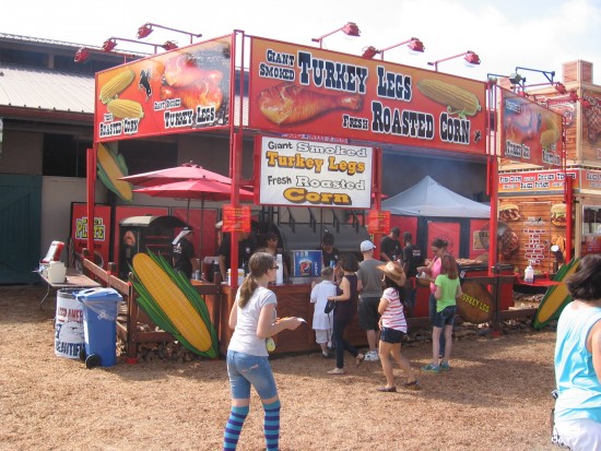 Giant smoked turkey legs and roasted corn.