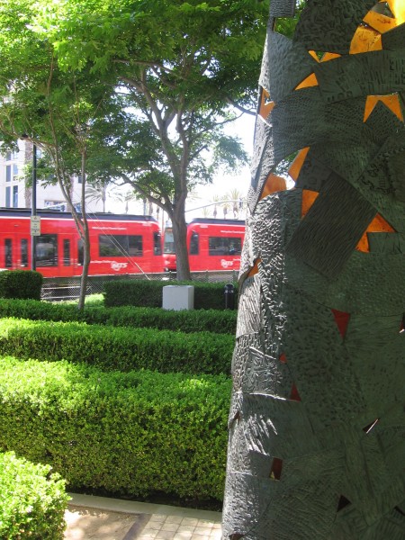 Trolley passes behind Shedding the Cloak.