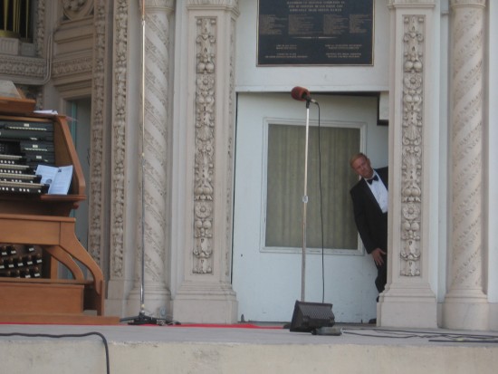 Elegant peek by organ assistant at the growing crowd.