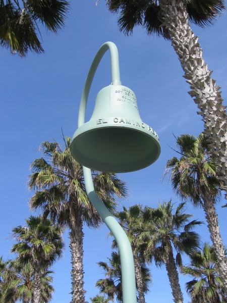 Historic bell and palm trees in Imperial Beach.