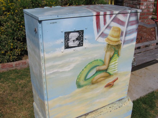 Utility box on Seacoast Drive shows girl playing in the sand.