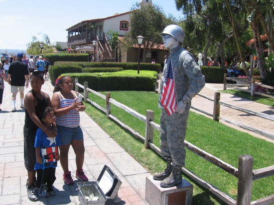 Street performer poses with red, white and blue.