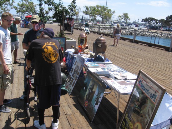 Young man near USS Midway speaks to retired Navy diver.