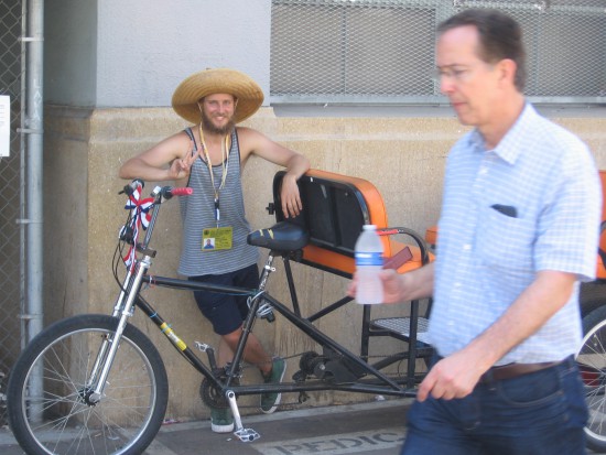 Cool pedicab driver gives a peace sign on Fourth of July.