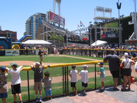 Folks watch a game at the kids ball field in Park at the Park.
