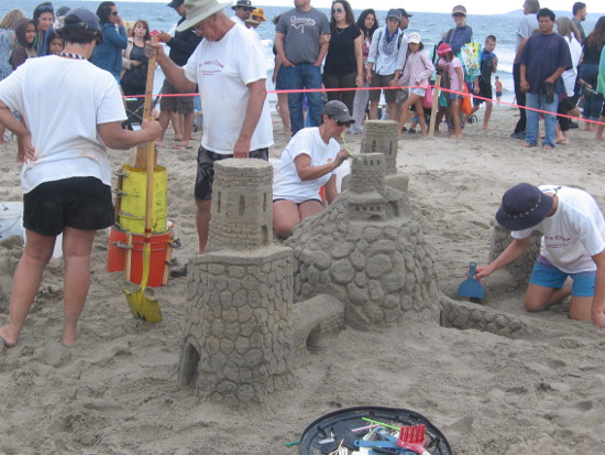 Teams north of Imperial Beach pier works on a detailed creations.