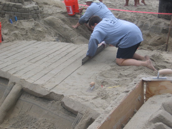 Long straight edge turns a broad swath of level sand into a boardwalk.