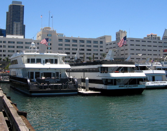 Harbor cruise ships with Navy Broadway Complex in the background.