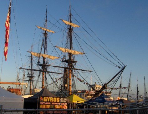 HMS Surprise of San Diego Maritime Museum and masts of visiting tall ships beyond.
