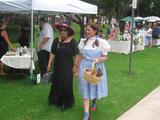 Dorothy and a Wicked Witch walk along checking out some art.