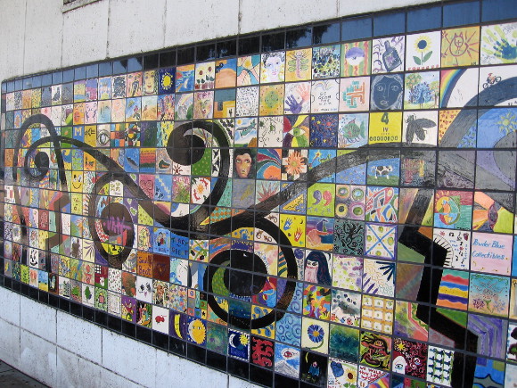 Hundreds of hand-painted tiles compose the colorful street mosaic.