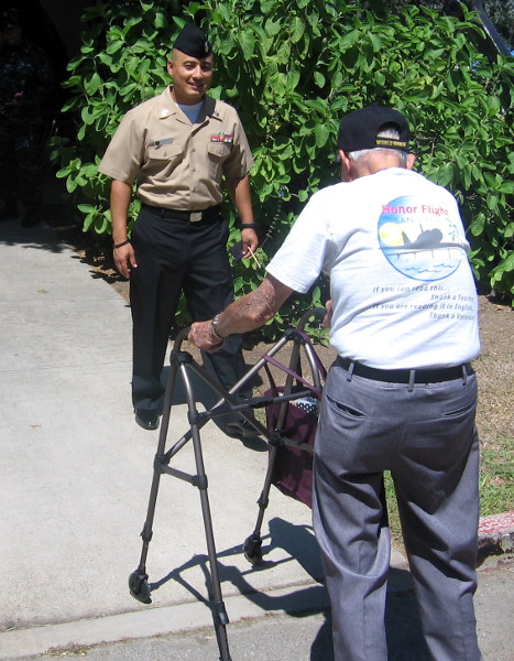 World War II veteran helped into museum side door.