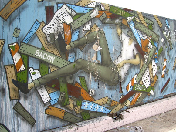 Jumbled, eye-catching mural on a fence on F Street.