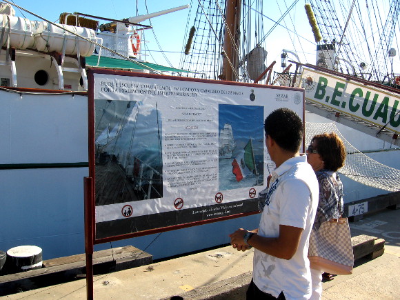 Visitors look at information sign near the Cuauhtémoc's gangplank.