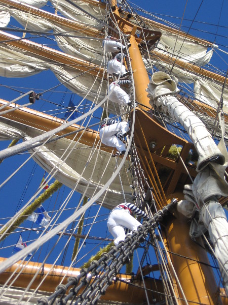 Higher they go up the enormous mast!