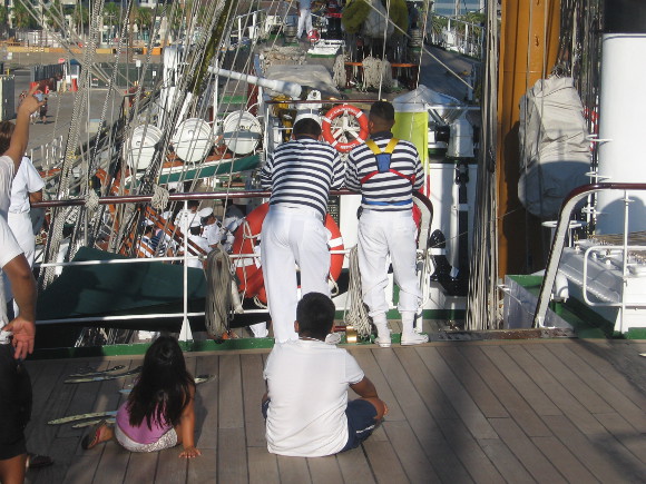 Guests and sailors watch the proceedings with interest.