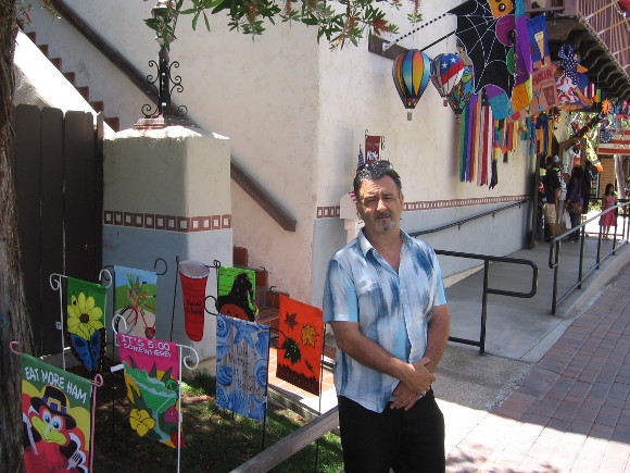 Mike Ismail in front of Alamo Flags in Seaport Village.