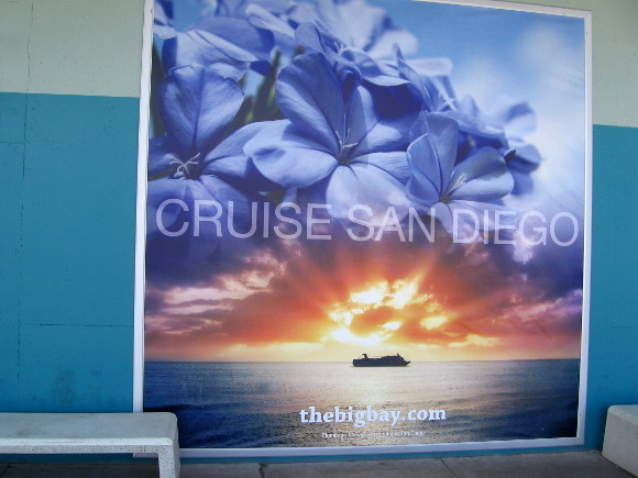 One of several promotional signs on the parking lot side of the terminal.