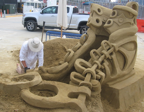 Kirk Rademaker works on his shoe sand sculpture on San Diego's B Street Pier.
