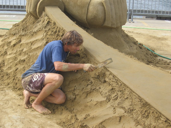 Chris Guinto concentrates as he carefully smooths an edge on his sculpture.