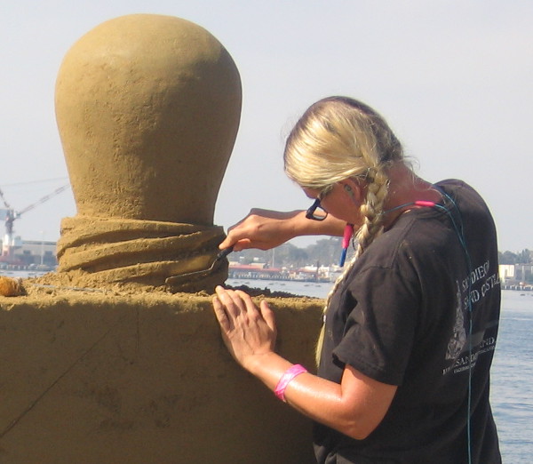 A close look at an artist sculpting with great care.