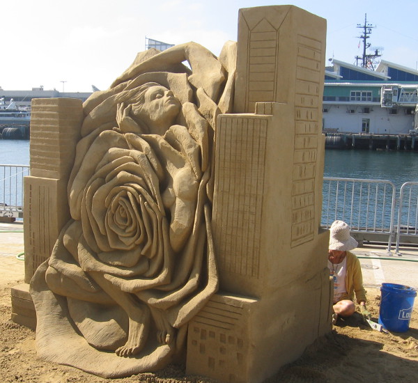 A huge sand rose and human form emerge on the other side!