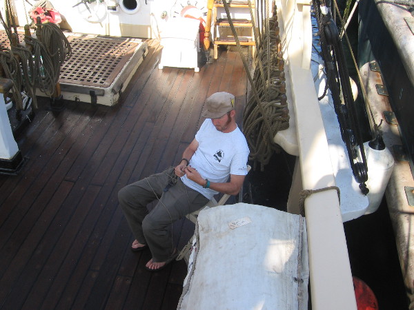 Pilgrim crew member works at a knot during San Diego's tall ship festival.