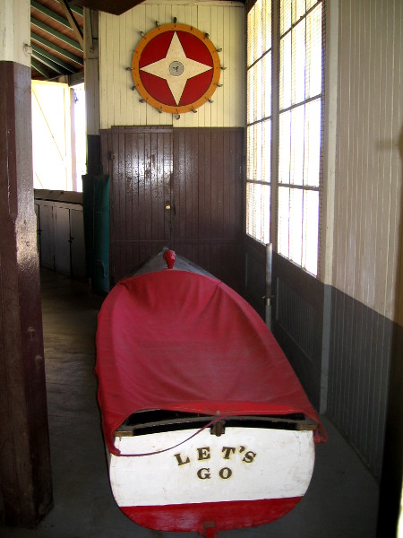 Old items in building include a rowboat.