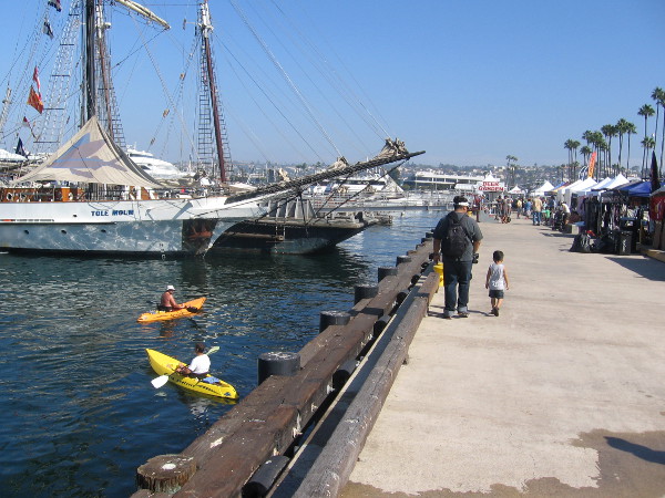 Man and boy walk along Embarcadero at San Diego's 2014 Festival of Sail.
